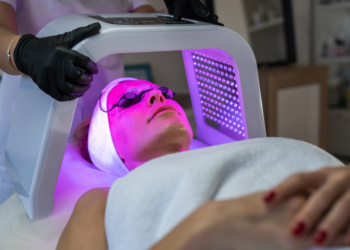a woman lying on the massage be getting LED light therapy
