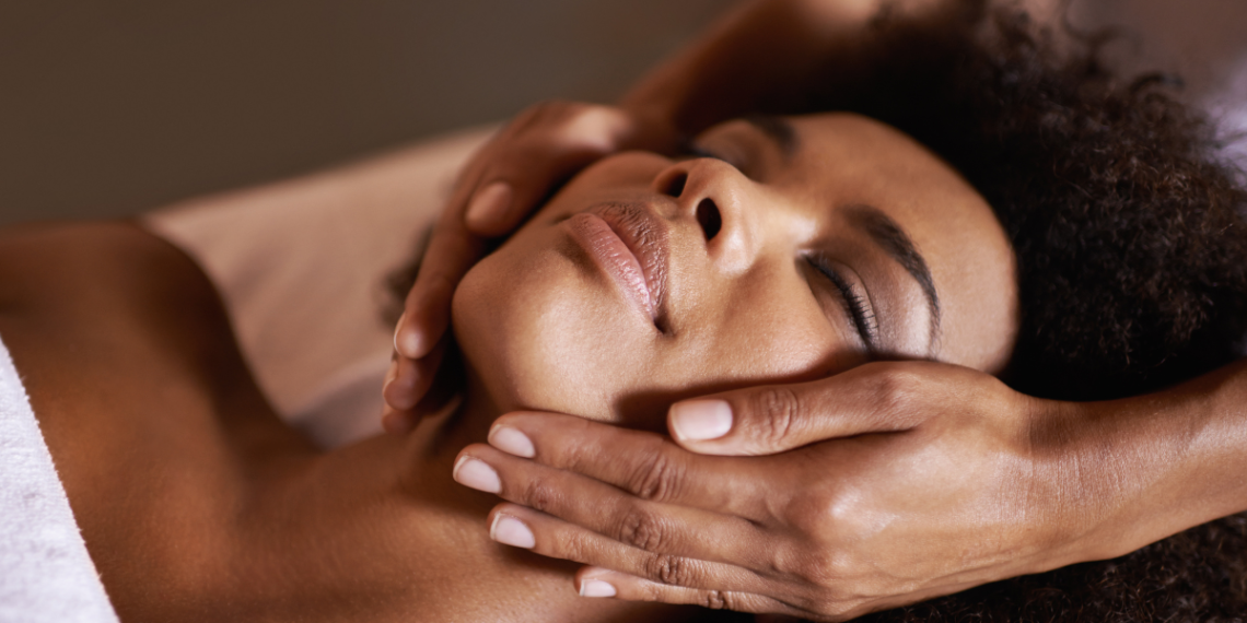 a black woman getting a facial.