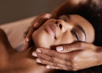 a black woman getting a facial.
